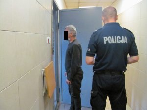 Zdjęcie przedstawiające policjanta z osoba zatrzymaną