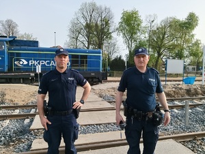 Dwóch policjantów na tle lokomotywy