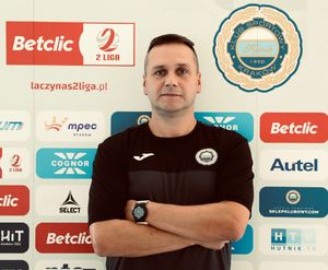 Mężczyzna na tle ścianki z logotypami różnych instytucji