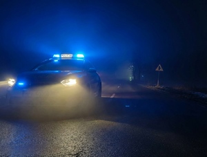 W scenerii nocnej radiowóz na otwartej szosie