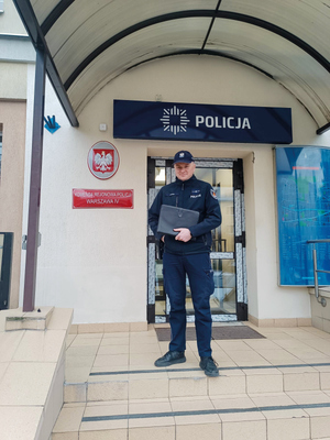 Policjant przed wejściem do jednostki policji